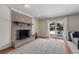 Living room with a brick fireplace, shiplap accent wall, and view of the outdoor pool and patio at 1352 Charlotte St, Altamonte Springs, FL 32701