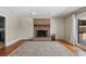Living room with a brick fireplace, shiplap accent wall, and access to the patio at 1352 Charlotte St, Altamonte Springs, FL 32701