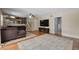 Open-concept living room with hardwood floors, gray sectional sofa, and view of the stairs at 1352 Charlotte St, Altamonte Springs, FL 32701
