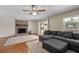 Bright living room featuring a brick fireplace, gray sectional sofa, and sliding glass doors at 1352 Charlotte St, Altamonte Springs, FL 32701