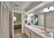 Bright bathroom with white cabinets, tile floor, and a view into the bedroom at 53 Paine Dr, Winter Haven, FL 33884