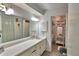 Well lit bathroom boasts long vanity countertop, large mirror, and is ready for your decor at 53 Paine Dr, Winter Haven, FL 33884