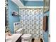 Bathroom featuring blue walls, a decorative vanity, and a patterned shower curtain at 53 Paine Dr, Winter Haven, FL 33884