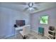 Bright bedroom with a workspace, ceiling fan, and natural light at 53 Paine Dr, Winter Haven, FL 33884