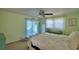 Comfortable bedroom with a ceiling fan and view to outdoor pool area, creates a relaxing and inviting atmosphere at 53 Paine Dr, Winter Haven, FL 33884