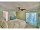 Comfortable bedroom with a ceiling fan and view to outdoor pool area, creates a relaxing and inviting atmosphere at 53 Paine Dr, Winter Haven, FL 33884
