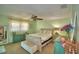Comfortable bedroom with a ceiling fan, dresser and bench create a relaxing and inviting atmosphere at 53 Paine Dr, Winter Haven, FL 33884