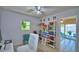 Comfortable bedroom with workspace and view of outdoor pool at 53 Paine Dr, Winter Haven, FL 33884