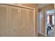 Hallway with a closet featuring bifold doors and leading into the main bedroom at 53 Paine Dr, Winter Haven, FL 33884