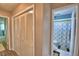 Hallway with a closet featuring bifold doors and leading into a bathroom at 53 Paine Dr, Winter Haven, FL 33884