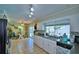 Bright kitchen with white cabinetry, granite countertops, and views of the backyard at 53 Paine Dr, Winter Haven, FL 33884