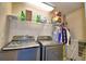 Well-lit laundry room with newer machines and shelving for storage at 53 Paine Dr, Winter Haven, FL 33884