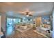 Spacious living room with a large sectional sofa, hardwood floors, and a patio view at 53 Paine Dr, Winter Haven, FL 33884