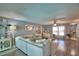 Bright living room featuring a neutral sectional, wood floors, and ample natural light at 53 Paine Dr, Winter Haven, FL 33884