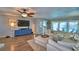 Open living room featuring modern furniture, a ceiling fan, and seamless indoor-outdoor flow at 53 Paine Dr, Winter Haven, FL 33884