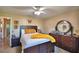 Inviting main bedroom featuring a large bed with nightstands and a large mirror sitting on a dresser at 53 Paine Dr, Winter Haven, FL 33884