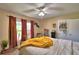 Well-lit main bedroom featuring dual windows, ceiling fan, and comfortable seating at 53 Paine Dr, Winter Haven, FL 33884