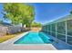 Enjoy the pool surrounded by a screen enclosed lanai and lush landscaping in this backyard retreat at 53 Paine Dr, Winter Haven, FL 33884