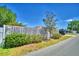Street view of the yard and home with a privacy fence and beautiful mature landscaping at 53 Paine Dr, Winter Haven, FL 33884