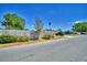 View of the house from the street with a nice privacy fence and mature landscaping at 53 Paine Dr, Winter Haven, FL 33884