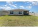 View of the spacious backyard with a well maintained lawn at 947 Serchio St, Haines City, FL 33844