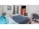 Bedroom with wood floors and a window with a Mario picture hanging on the wall at 947 Serchio St, Haines City, FL 33844