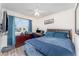 Bedroom showcasing natural light, wood-look floors, and cozy decor with dresser, and desk at 947 Serchio St, Haines City, FL 33844