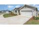 Charming home exterior with a clean two-car garage and meticulously landscaped front yard at 947 Serchio St, Haines City, FL 33844