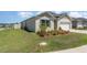 Well-manicured lawn and landscaping enhance this home's curb appeal at 947 Serchio St, Haines City, FL 33844