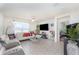 Bright living room with modern furnishings, tiled floors, and ample natural light, perfect for relaxation at 947 Serchio St, Haines City, FL 33844