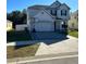 Charming two-story home with a paver driveway and basketball hoop at 2121 Amor Way, Leesburg, FL 34748