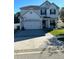 Charming two-story home with a paver driveway and basketball hoop at 2121 Amor Way, Leesburg, FL 34748