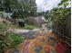 View of backyard, trash cans, and painted concrete at 1529 Indiana St, Orlando, FL 32805