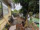 Backyard with greenery, some chairs and plants with a yellow colored wall at 1529 Indiana St, Orlando, FL 32805