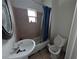 A basic bathroom featuring a sink, toilet, tub, and window at 1529 Indiana St, Orlando, FL 32805