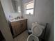 Bathroom featuring a modern vanity, tiled floors, and natural light from a window at 1529 Indiana St, Orlando, FL 32805