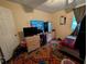 Bedroom with a carpet and filled with a bed, a tv and other bedroom furniture at 1529 Indiana St, Orlando, FL 32805