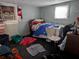 Image of a bedroom with a bed, clothing, and a messy floor at 1529 Indiana St, Orlando, FL 32805