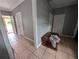 Tile hallway leading to exterior doors features a small wood table against the wall at 1529 Indiana St, Orlando, FL 32805