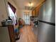 Galley kitchen with stainless steel refrigerator and appliances and wood laminate flooring at 1529 Indiana St, Orlando, FL 32805