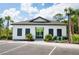 Exterior of community building with white walls, black shutters, and lush greenery at 3273 Vesara Dr, Davenport, FL 33837