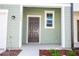 Charming home featuring a welcoming front door, well-kept landscaping, and stylish exterior details at 3273 Vesara Dr, Davenport, FL 33837
