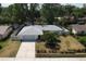 Charming single-story home with mature trees, well-maintained landscaping, and a fenced backyard at 3446 Country Manor Dr, Port Orange, FL 32129