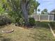 Landscaped back yard with flower beds and mature trees at 3446 Country Manor Dr, Port Orange, FL 32129