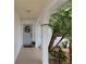 Inviting front porch adorned with brick columns, decorative wreath, and lush landscaping at 3446 Country Manor Dr, Port Orange, FL 32129
