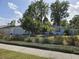 Well-manicured front yard with a charming one-story home and attached garage at 3446 Country Manor Dr, Port Orange, FL 32129