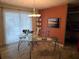 Bright home office space with a modern glass desk and sliding glass doors for natural light at 3446 Country Manor Dr, Port Orange, FL 32129
