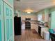 Modern kitchen featuring white cabinets, stainless steel appliances, and wood-look flooring at 3446 Country Manor Dr, Port Orange, FL 32129