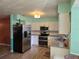 Well-lit kitchen with stainless steel appliances, white cabinets, and bright, colorful accent walls at 3446 Country Manor Dr, Port Orange, FL 32129