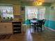 Cozy kitchen nook featuring a table, chairs, and natural light from multiple windows at 3446 Country Manor Dr, Port Orange, FL 32129